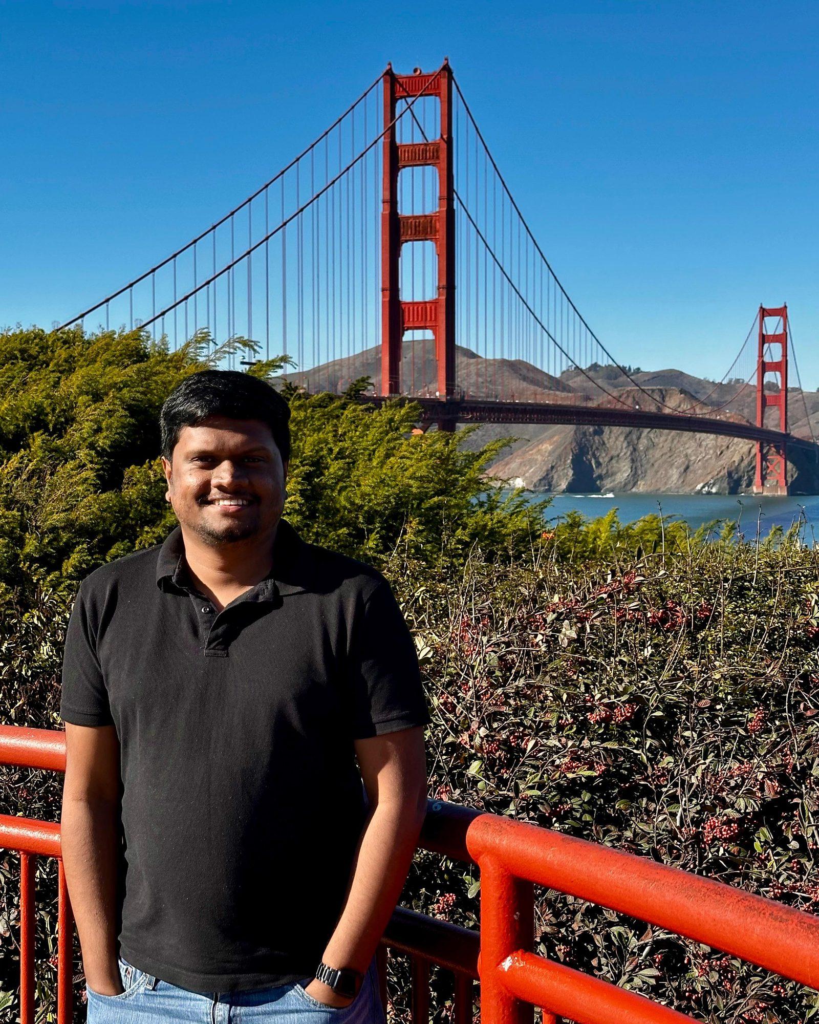 Dulan Dias smiling in front of the Golden Gate Bridge, San Francisco