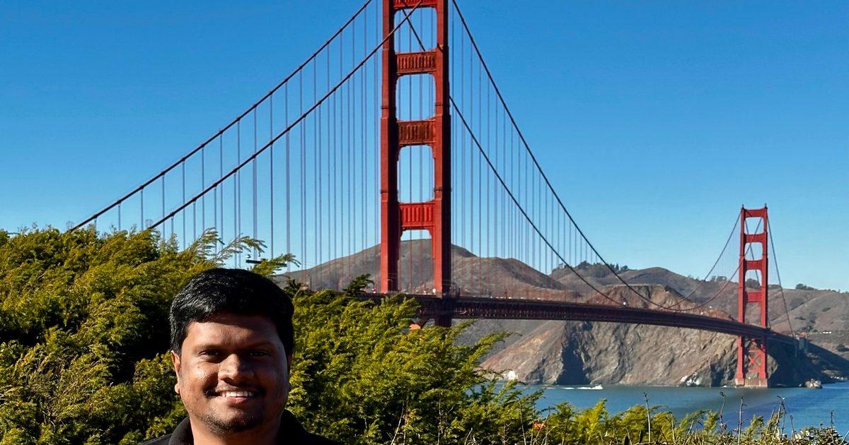 Dulan in front of the Golden Gate Bridge on a clear day